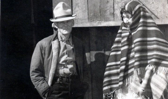 Snapshot of W. F. Murphy Sr. and Ruby (Wolf) Murphy standing in front of a barn, taken in the 1930s or '40s